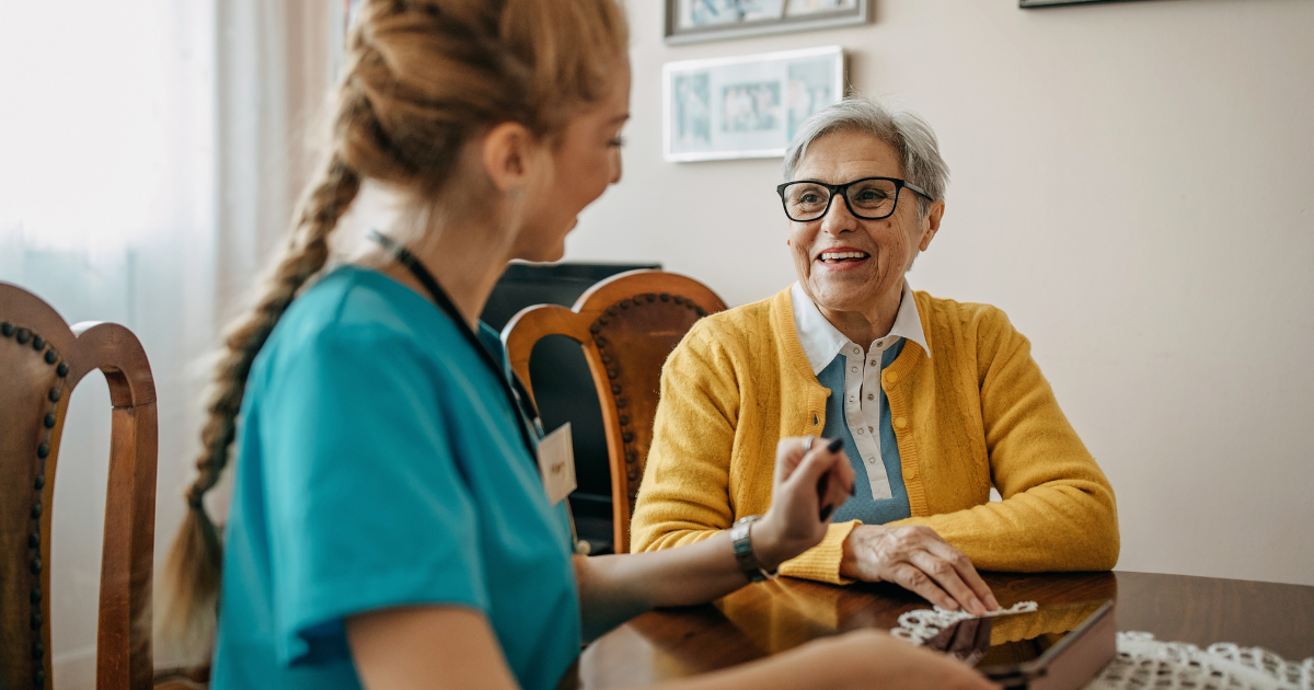 A senior woman enjoys the benefits of private duty care as her caregiver checks in on her.