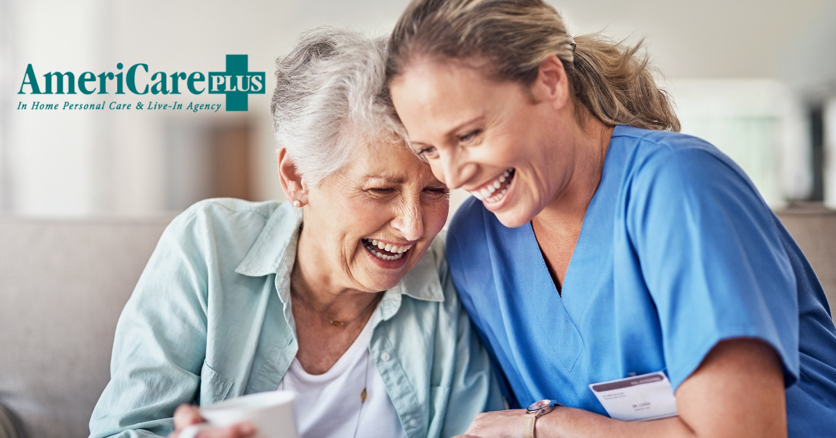 A woman who is providing companion care and her senior client laugh and enjoy their time together.