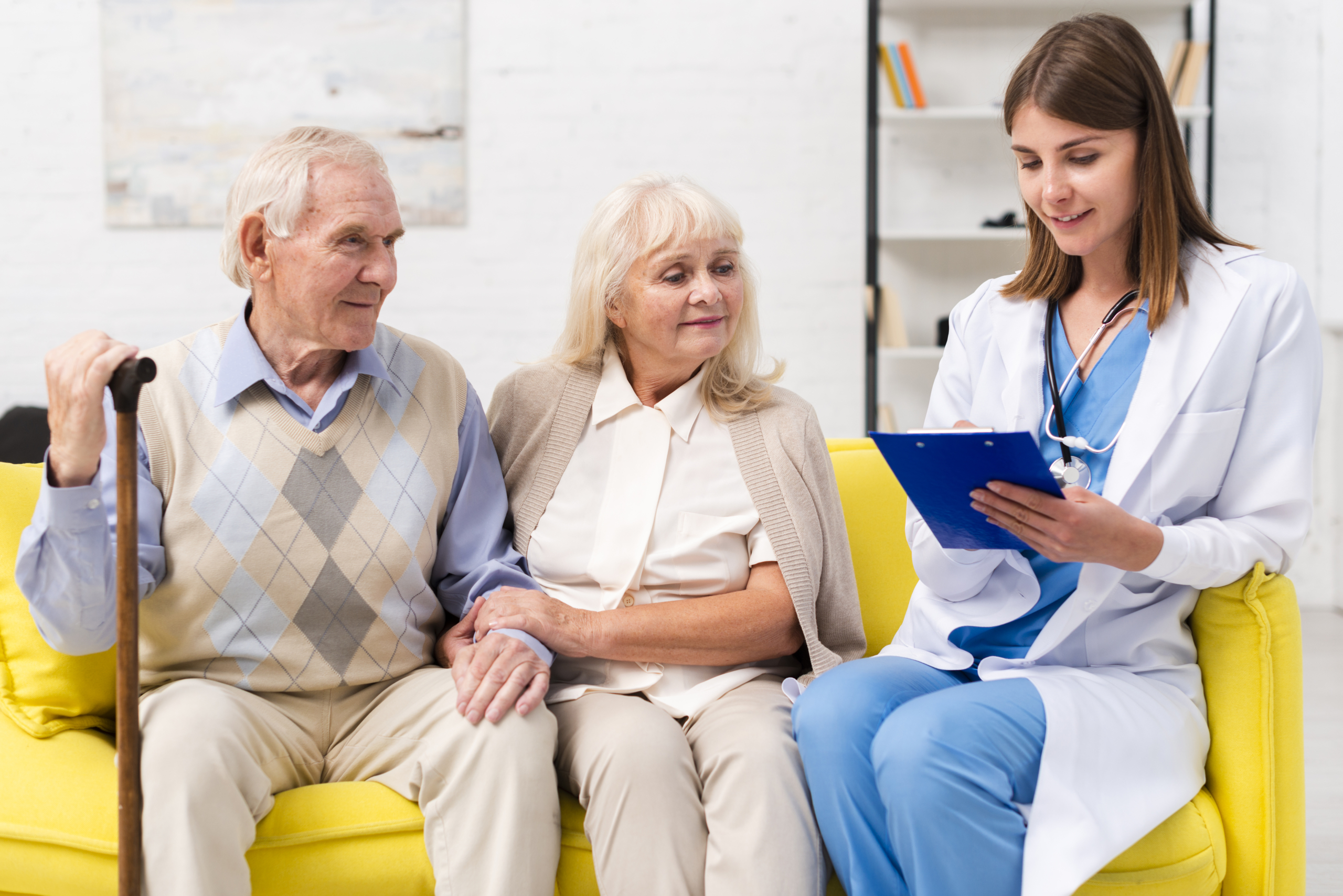 nurse-sitting-with-old-man-woman-sofa