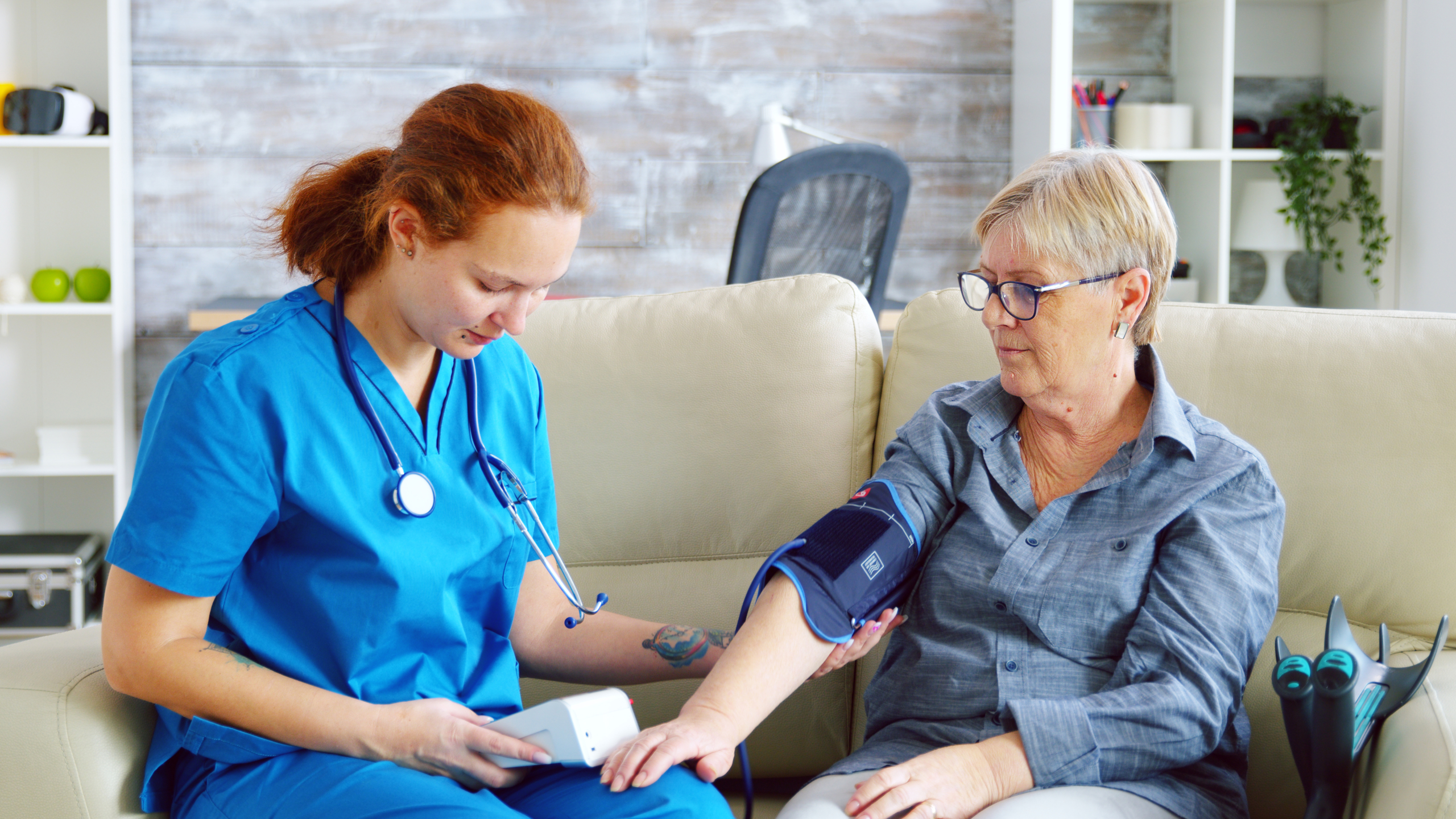 Female doctor taking blood pressure of senior woman Dementia Care in Charlottesville