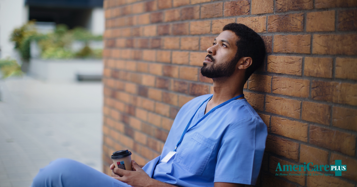 An exhausted professional caregiver takes a break outside.