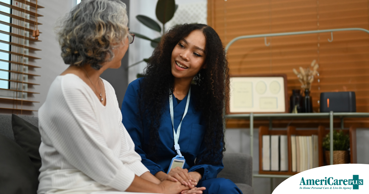 A caregiver patiently and kindly sits down and talks with a senior client, setting a good example for caregivers when it comes to communication.