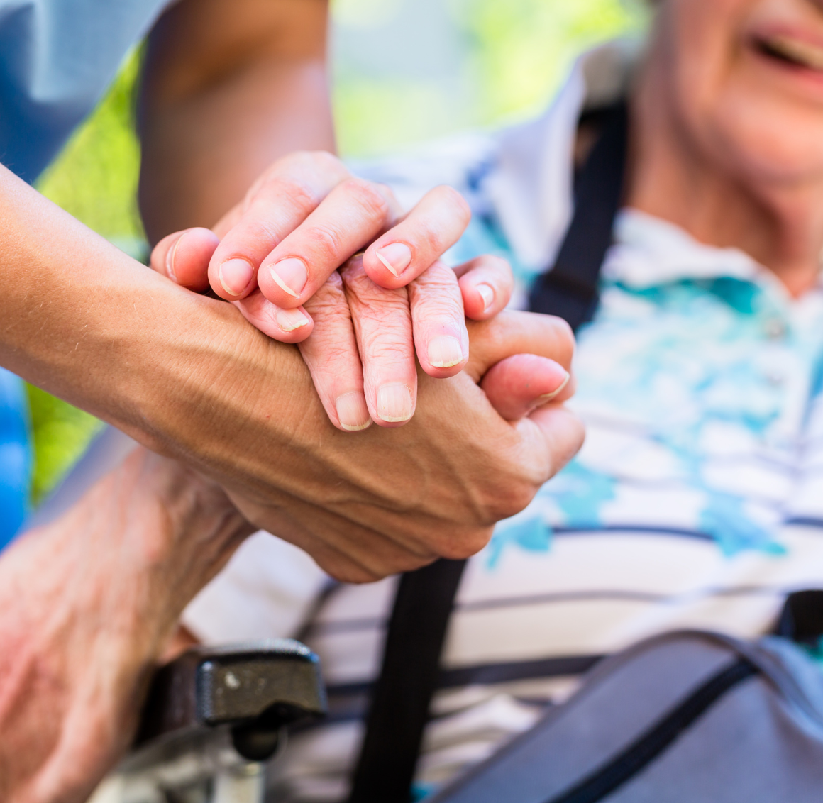 A caregiver holds an older adult's hand, representing how post-operative care in Lexington can help those who need it.