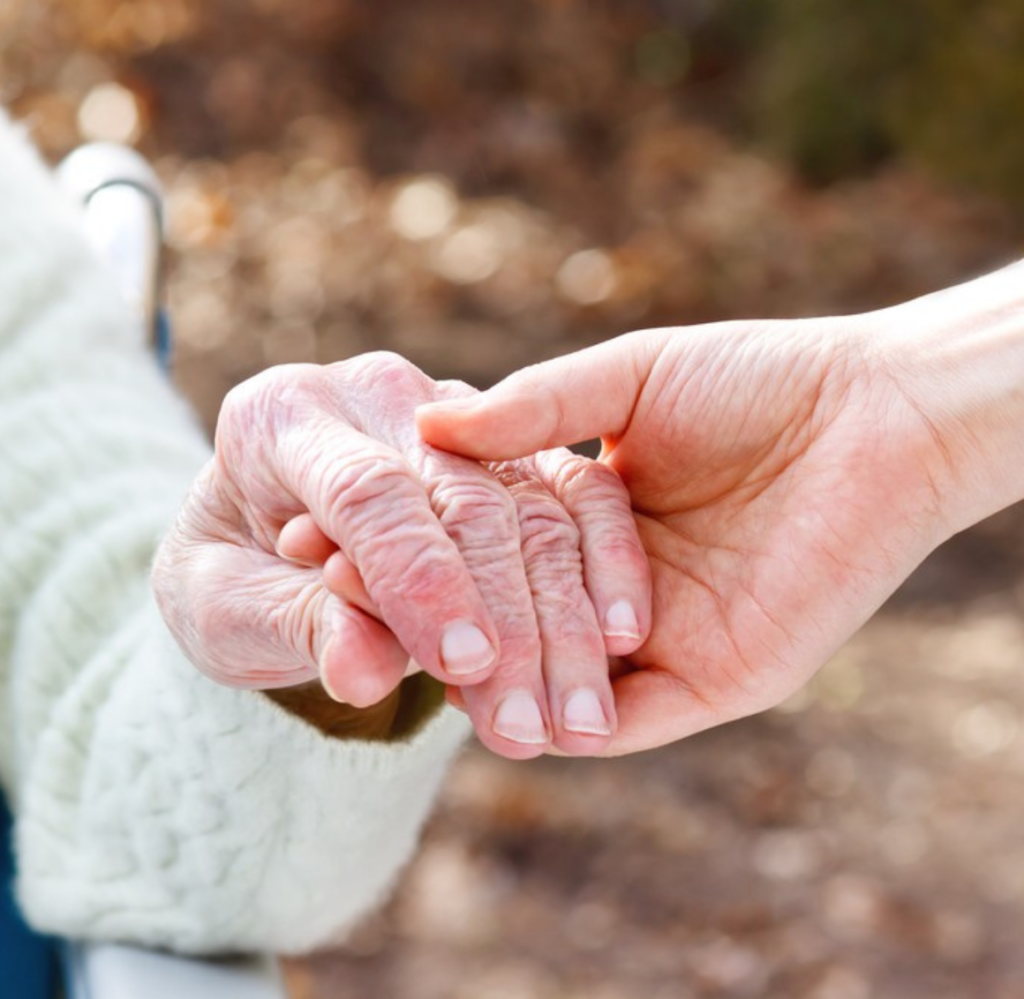 Untitled design (55) A young hand holds an older one, representing the support that Life Coordinated can bring to those in Mecklenburg County, VA.