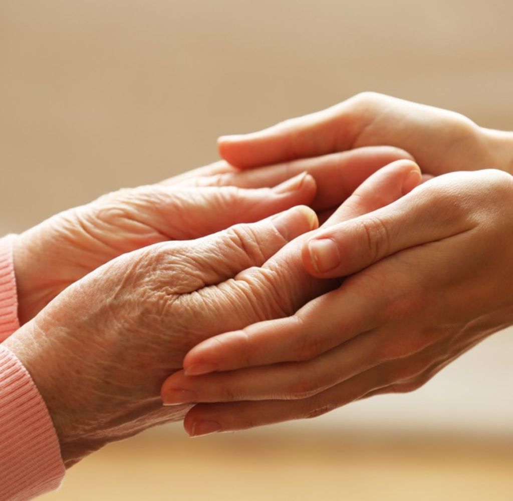 Young hands hold elderly hands, representing the support that 24-Hour Live-In Care in Mecklenburg County, VA can provide.