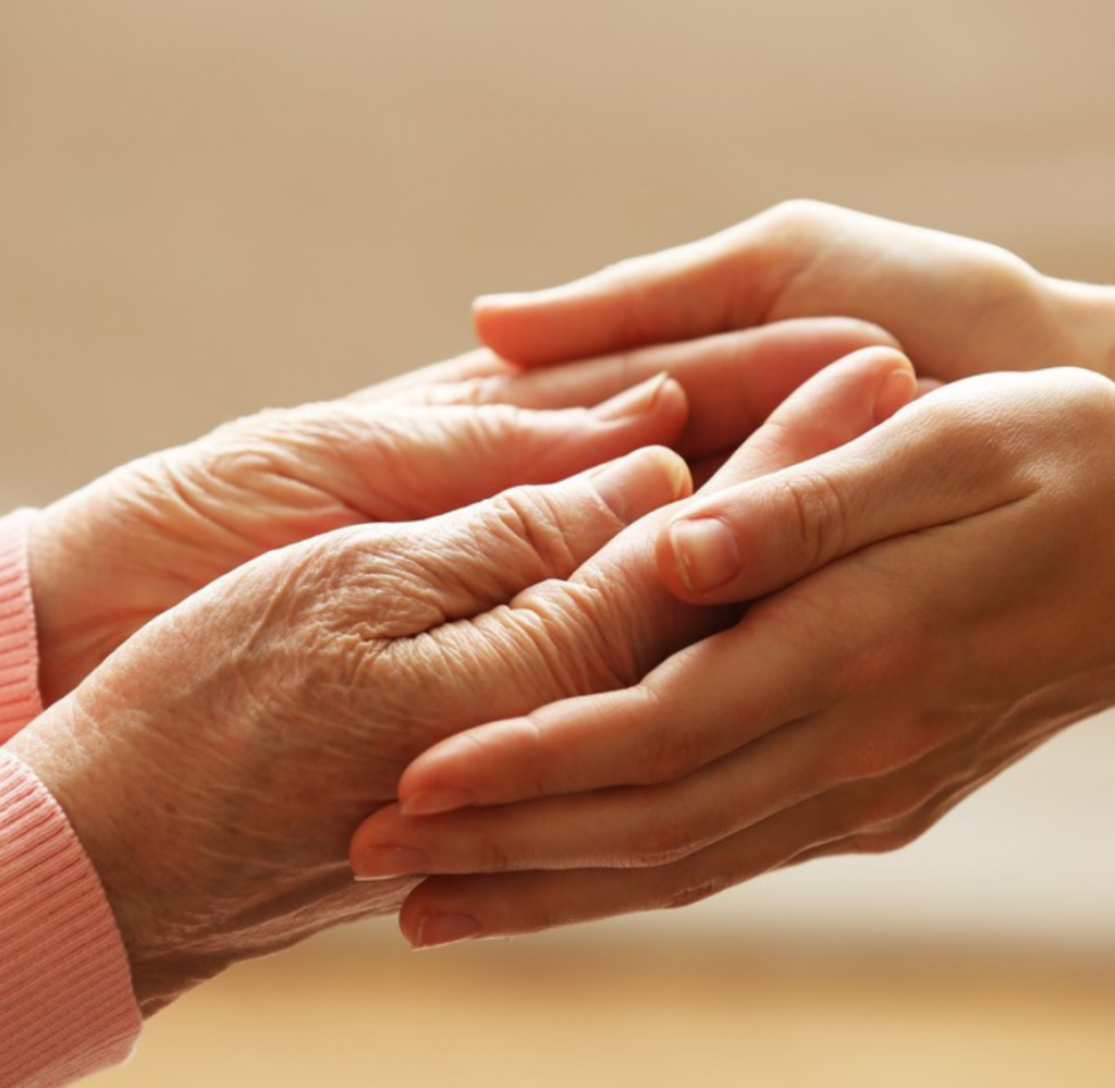 Untitled design (56) Young hands hold elderly hands, representing the support that 24-Hour Live-In Care in Mecklenburg County, VA can provide.