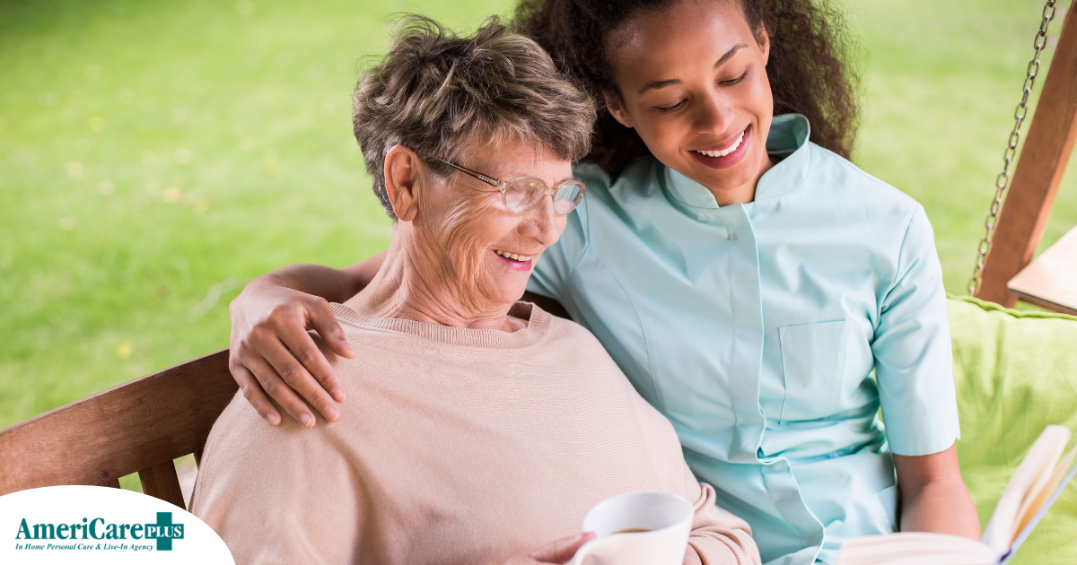 Professional caregivers like this one who is reading a book with a senior client can help them stay mentally active and engaged.