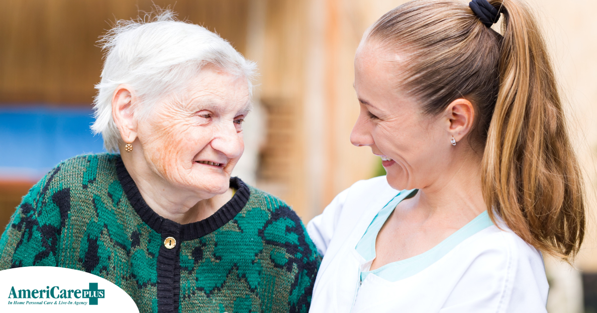 A professional caregiver compassionately hugs a senior client.