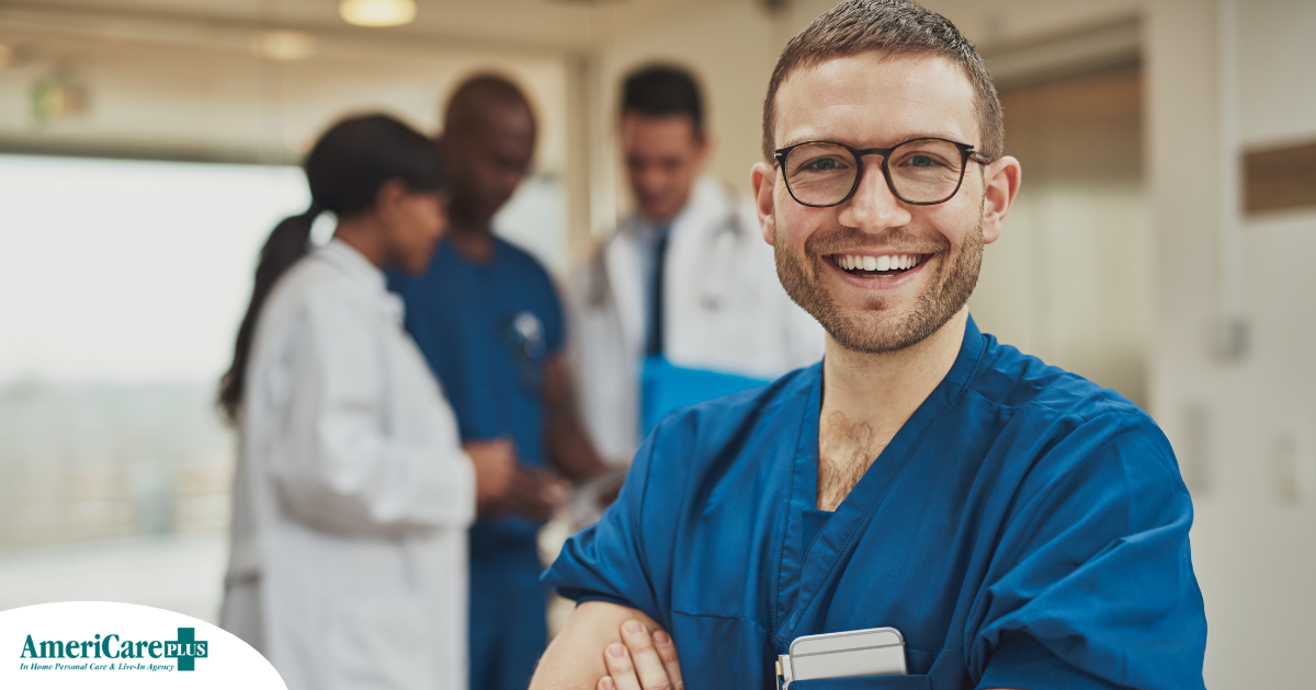 A young man in healthcare smiles, representing how a career as a professional caregiver can lead to a happy career as a healthcare professional.