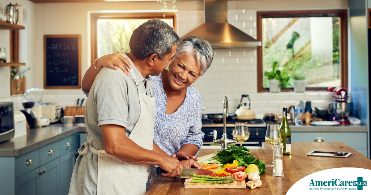 A senior couple enjoys cooking a healthy meal together, representing National Nutrition Month.