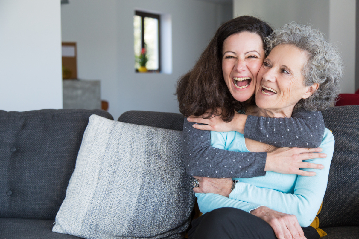 A daughter happily embraces her elderly mother, representing how Life Coordinated can help caregivers and care recipients enjoy life in Mecklenburg County, VA.