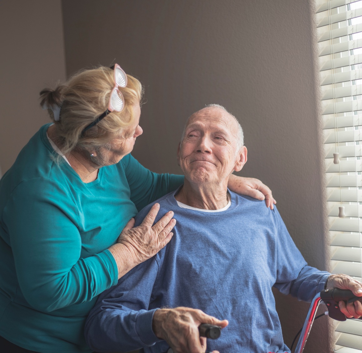 A caregiver an older adult smile and enjoy time together, representing quality Respite Care in Mecklenburg