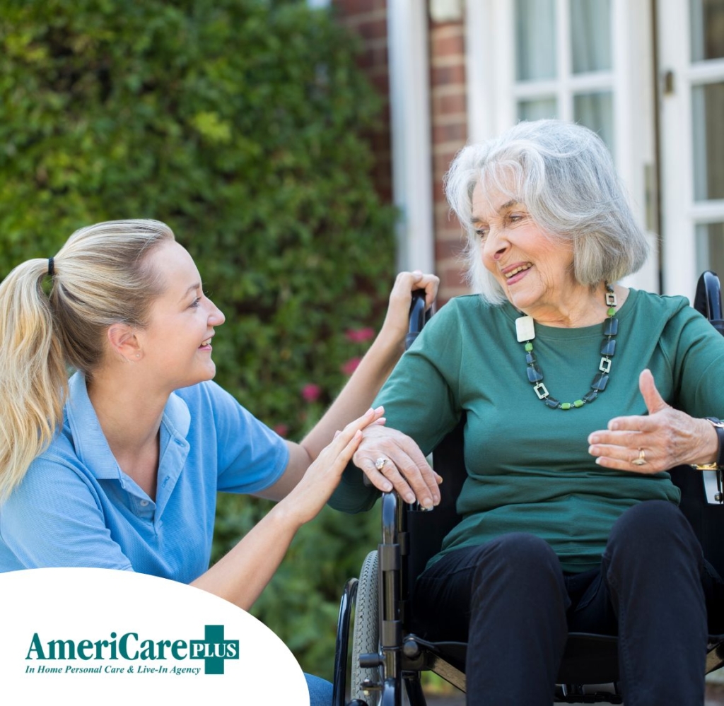 A caregiver helps an older client in a wheelchair, representing dementia care in Orange.