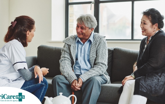 A caregiver talks with an elderly couple representing the kind of communication that professional caregivers need to have to anticipate client needs.