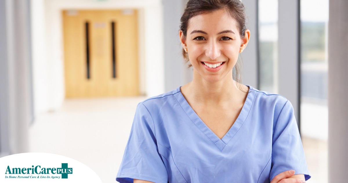 A woman in scrubs smiles, representing the good results that can come when caregivers branch out to become CNAs.