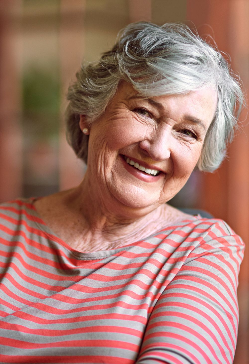 Smiling senior woman sitting comfortably indoors while receiving home care support in Carrollton, VA
