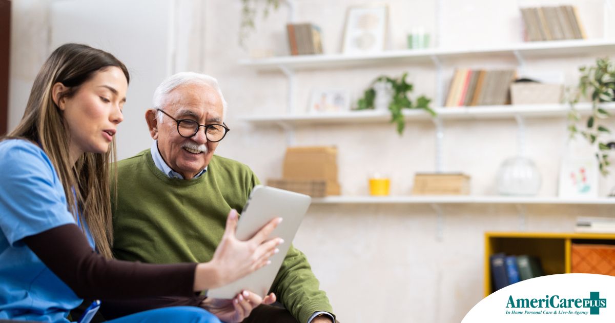 Telehealth and Senior Care Home caregiver assisting senior man to use telehealth and senior care