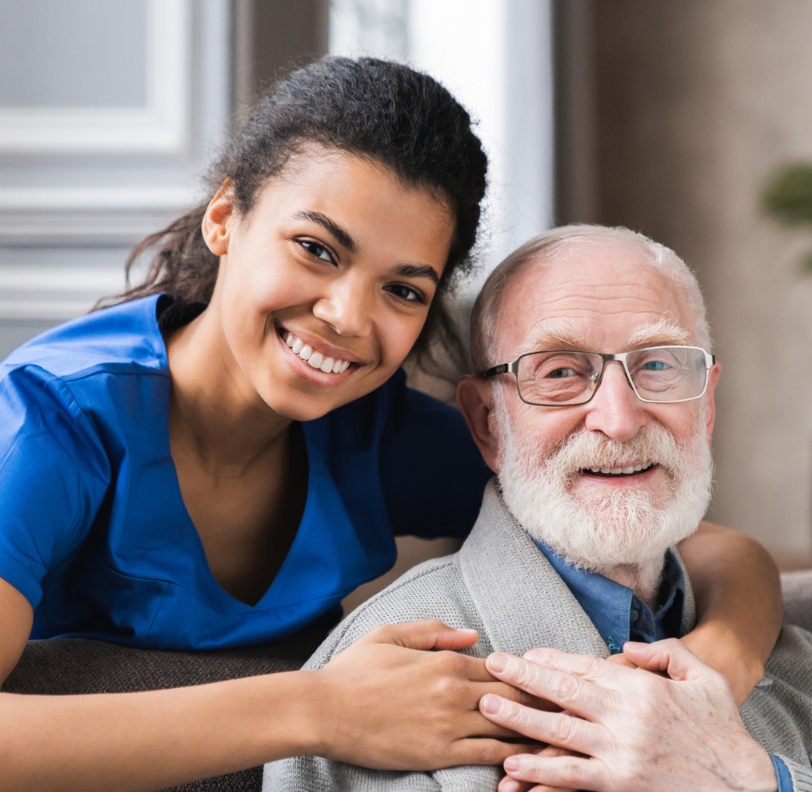 Caregiver embracing smiling senior man indoors, companion care in Waynesboro VA